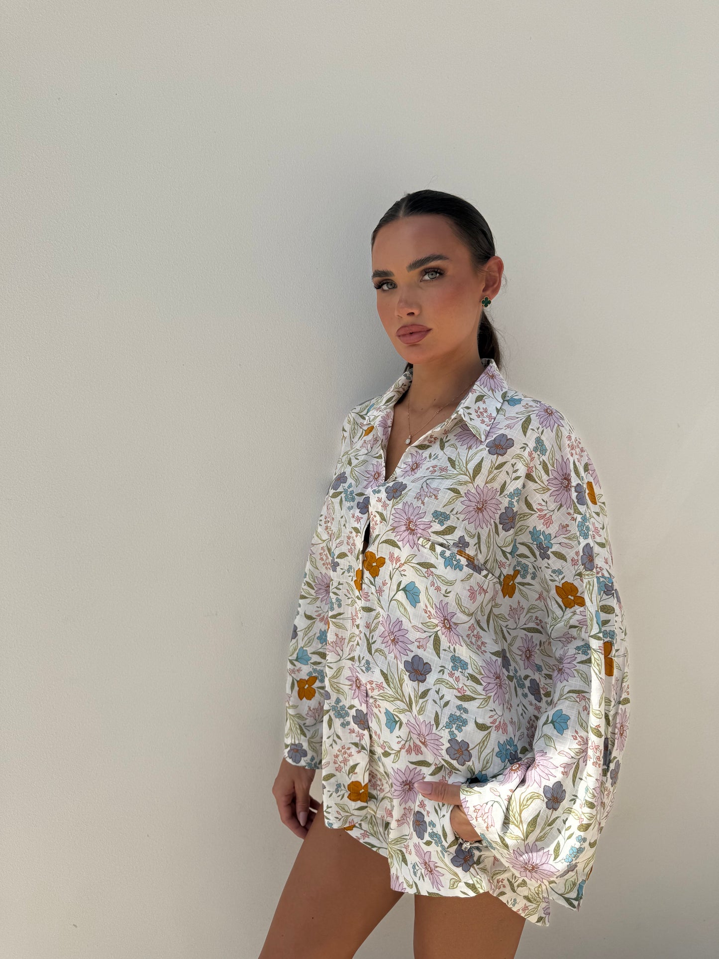 Woman in floral button-down shirt and matching shirt