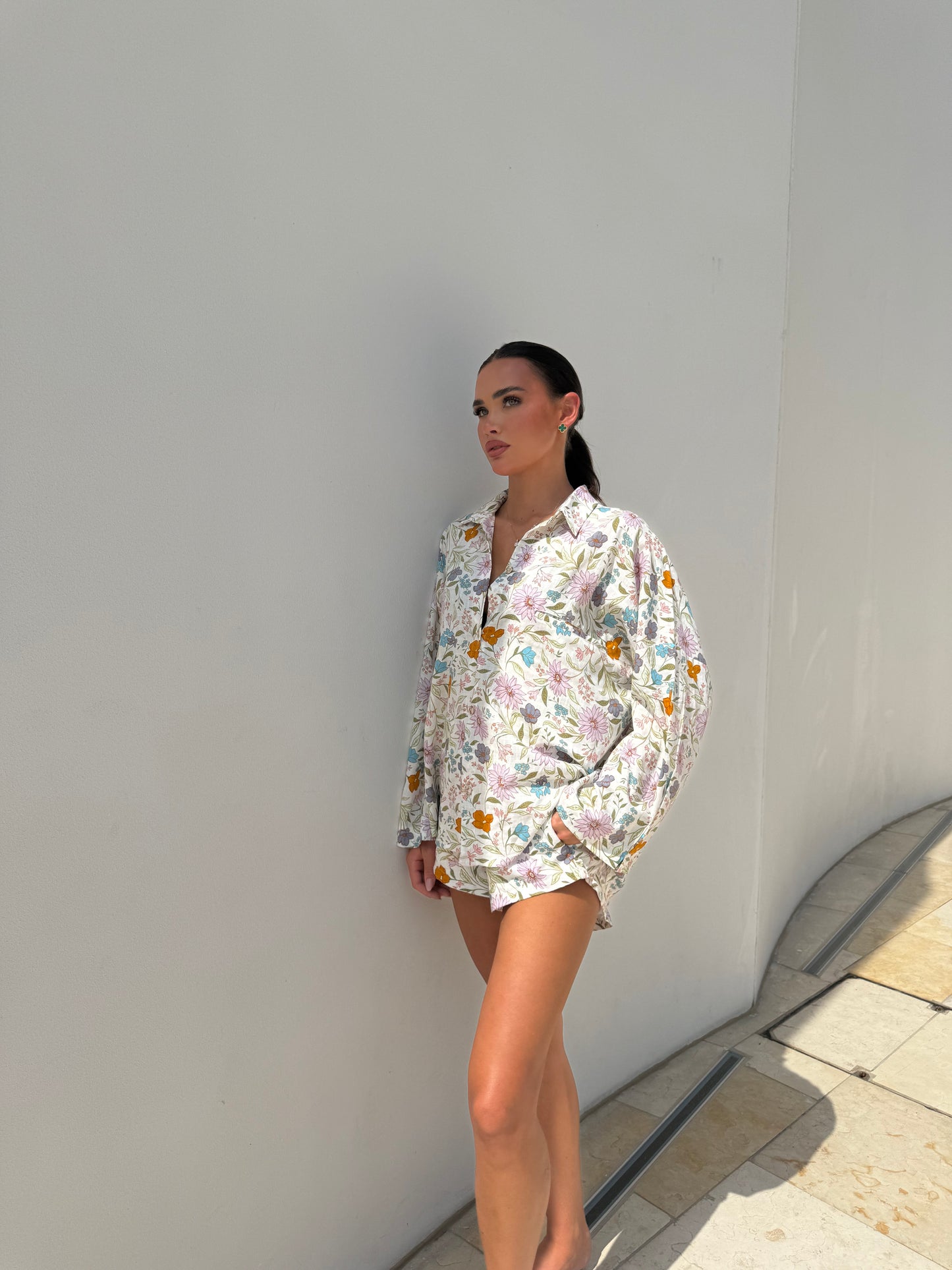 Model wearing relaxed floral shirt and shorts perfect for warm weather