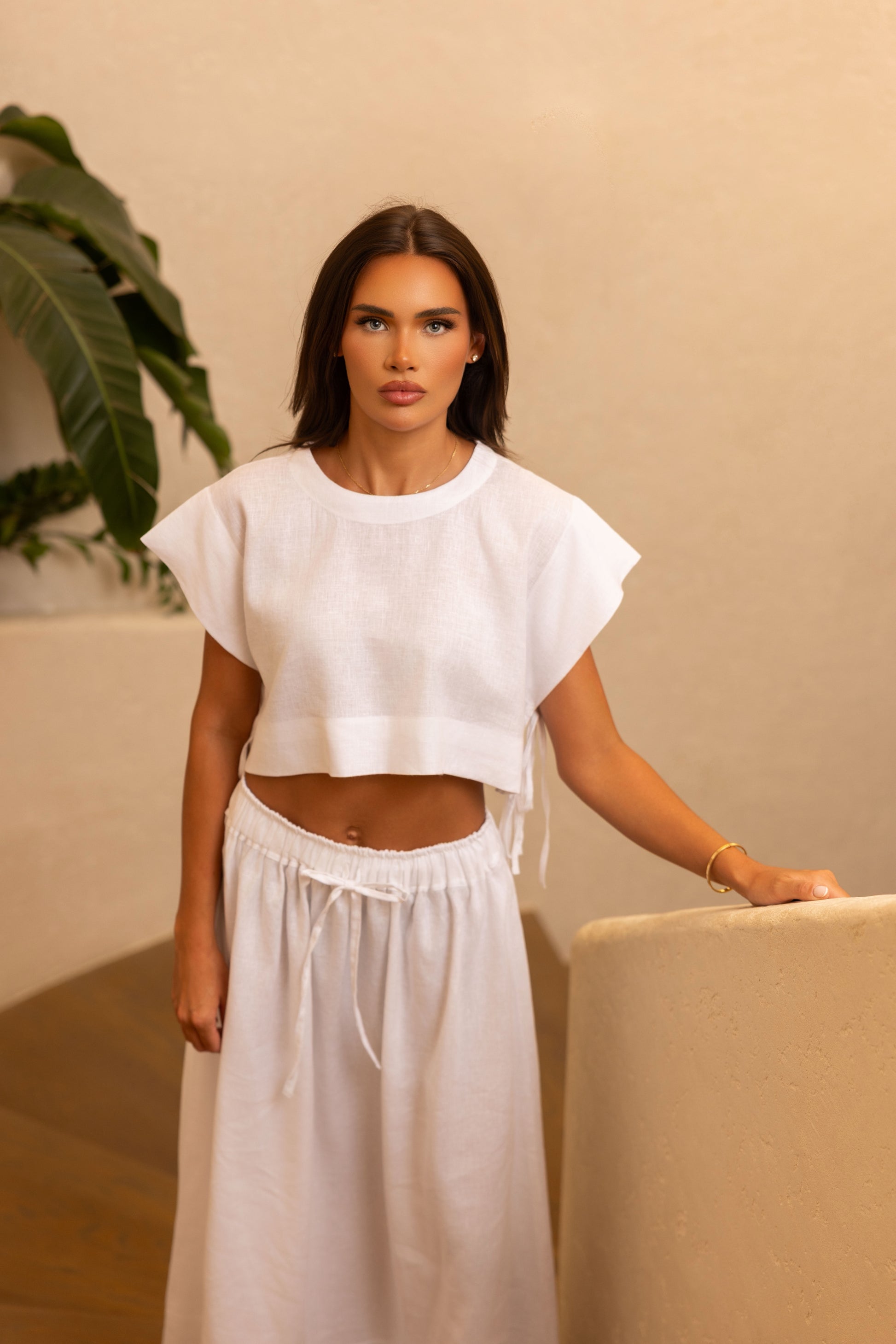 Tie-side linen top styled with neutral skirt